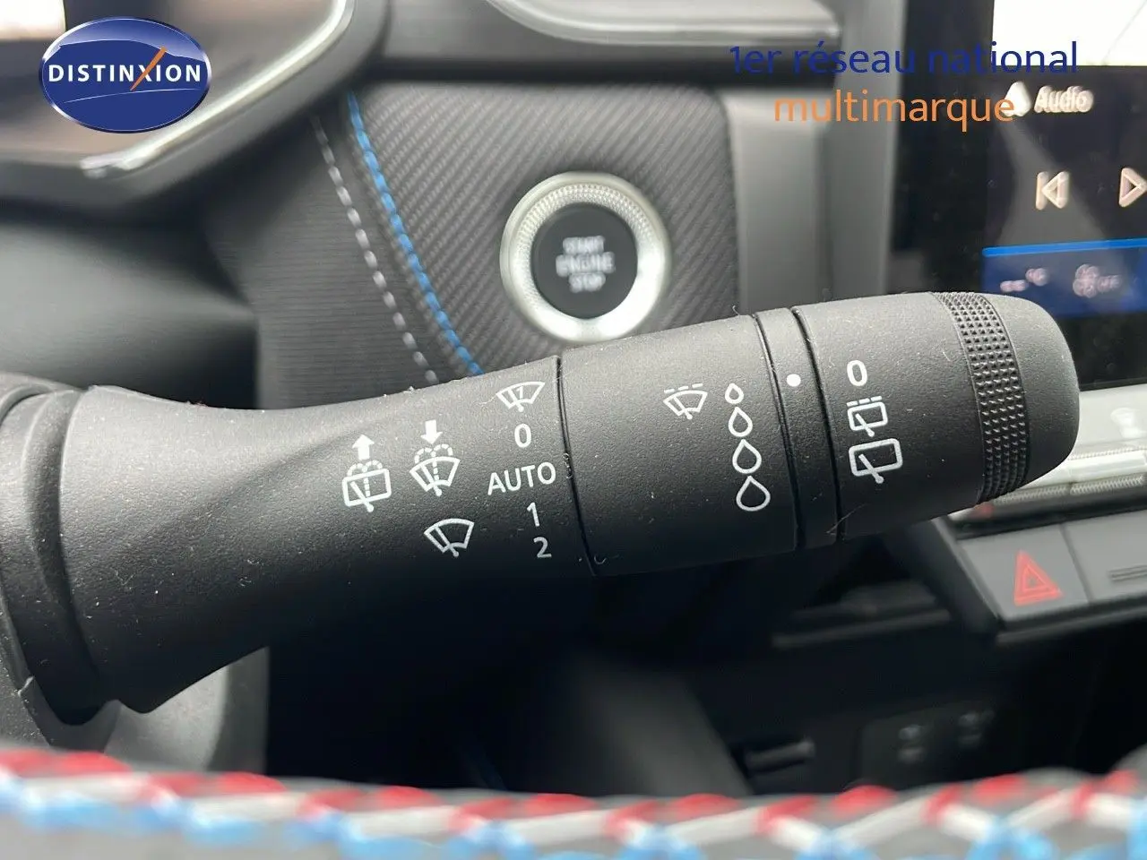 Gros plan sur la commande d’essuie-glace du Renault Symbioz gris rafale métal, avec bouton start engine stop en arrière-plan.