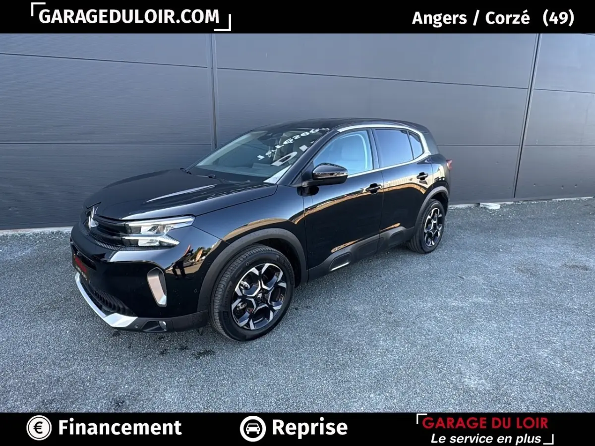 SUV Citroën C5 Aircross noir en 3/4 avant droit, avec jantes noires et détails chromés visibles sur fond urbain.