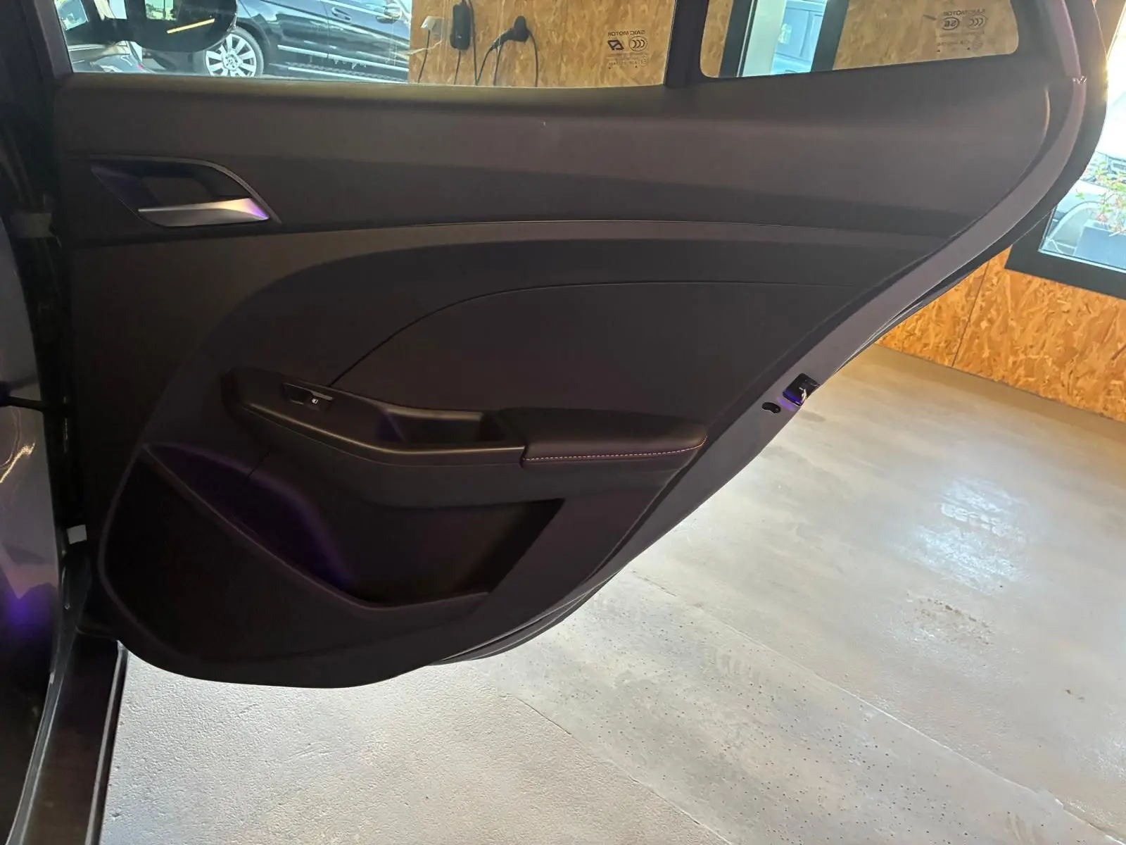 Vue intérieure de la porte arrière gauche noire du MG3 1.5 HYBRID+ 195 LUXURY avec garniture sobre et poignée intégrée.