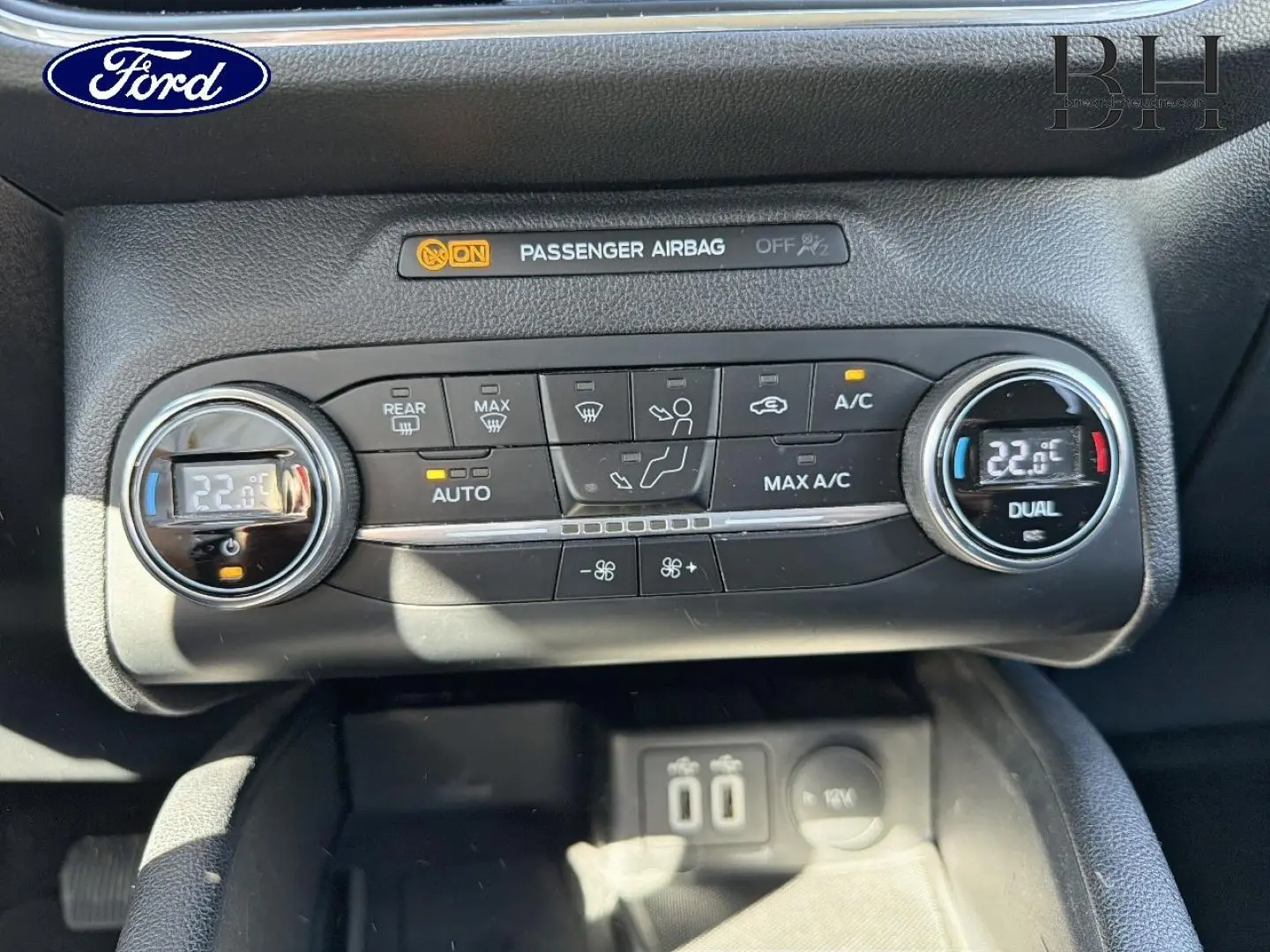 Vue rapprochée de la console de climatisation bi-zone noire du Ford Kuga 2021 avec affichage digital à 22°C.