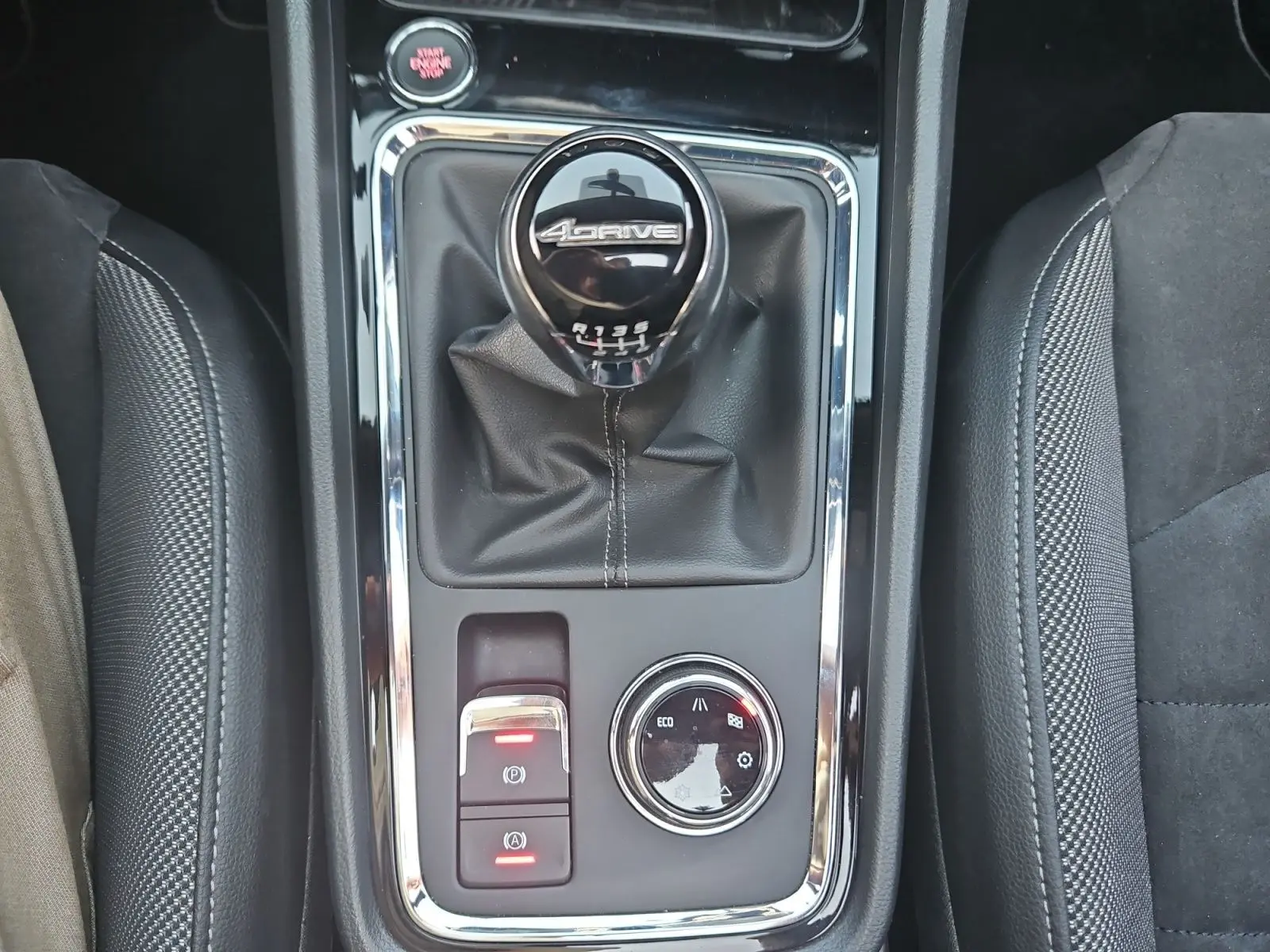 Gros plan sur la console centrale du SEAT Ateca blanc, mettant en valeur le levier de vitesses manuel 6 rapports 4Drive.