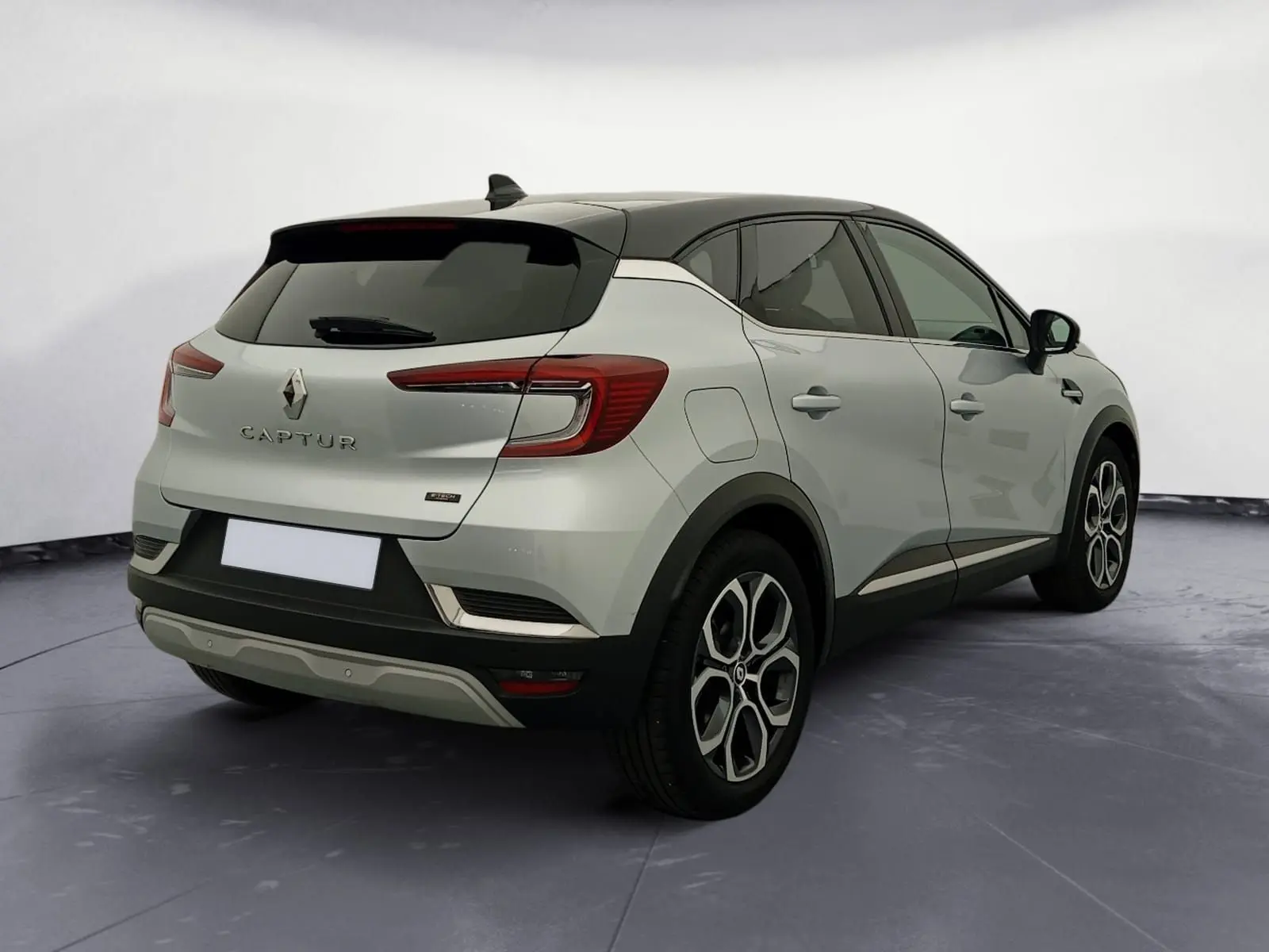 Renault Captur E-Tech Full Hybrid 145 Techno 2023 gris alu/noir, vue 3/4 arrière droit avec toit noir et jantes 18 pouces.