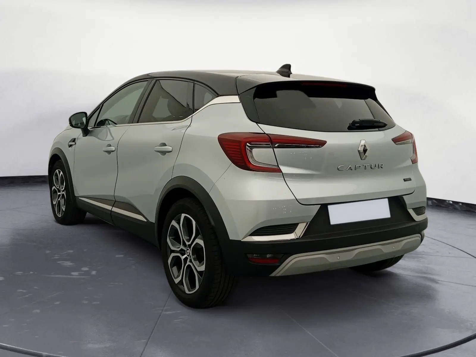 Renault Captur E-Tech Full Hybrid 145 Techno 2023 en gris alu et noir, vue 3/4 arrière avec jantes 18 pouces.