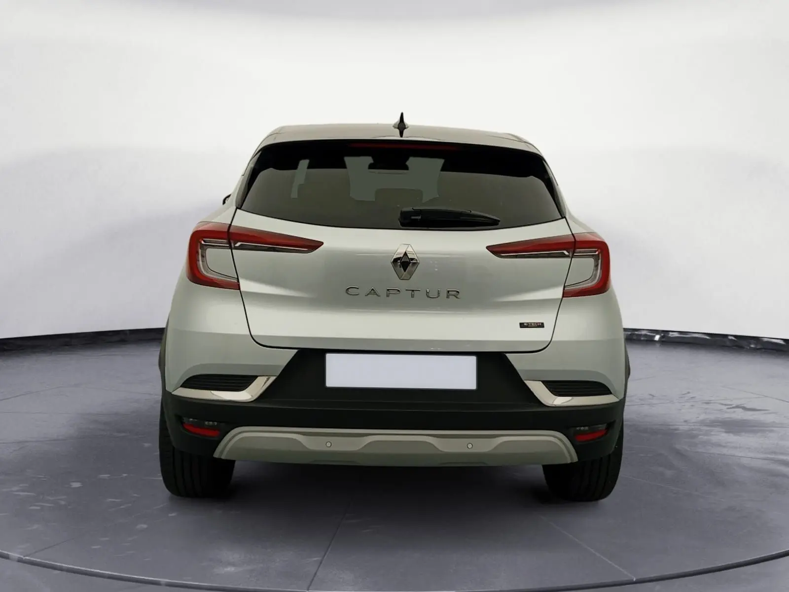 Vue arrière d'un Renault Captur 2023 gris alu avec toit noir, feux LED et badge E-Tech Full Hybrid.