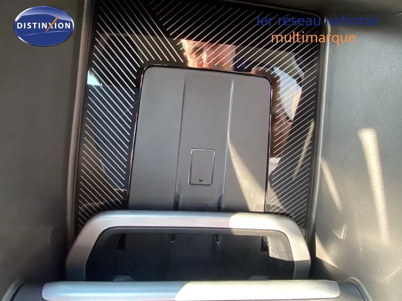 Vue rapprochée de la console centrale du BMW X1 18I bleu phytonic metal, mettant en valeur le rangement et les finitions modernes.