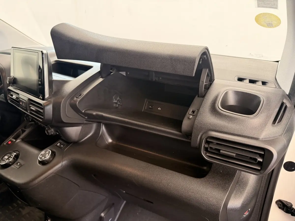 Intérieur du Citroën Berlingo 2019, vue côté passager sur la boîte à gants ouverte et la console noire.