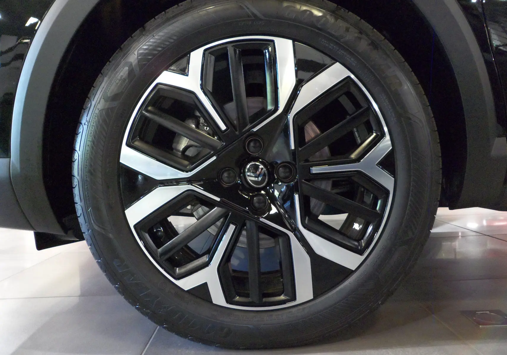Gros plan sur la jante noire et argentée au design géométrique du Citroën C4 Hybride 2025 Noir Perla.