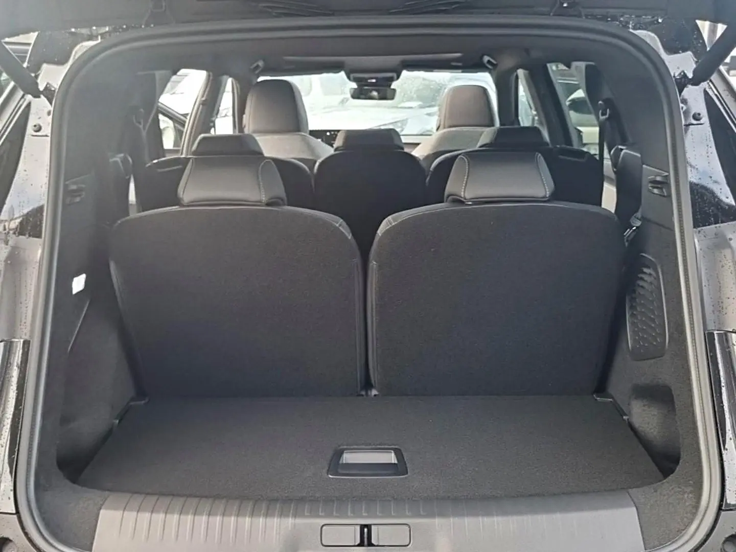 Vue arrière ouverte sur le coffre et les trois rangées de sièges noirs du Peugeot 5008 Hybrid 145 GT e-DCS6 2026.