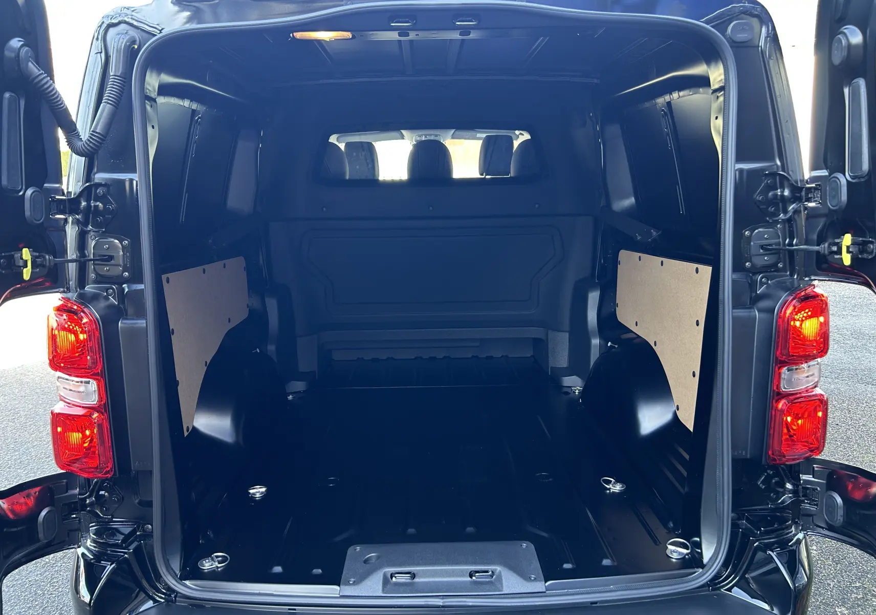Vue arrière ouverte du Citroën Jumpy Cabine Approfondie noir, montrant l’espace de chargement vide et les portes battantes.