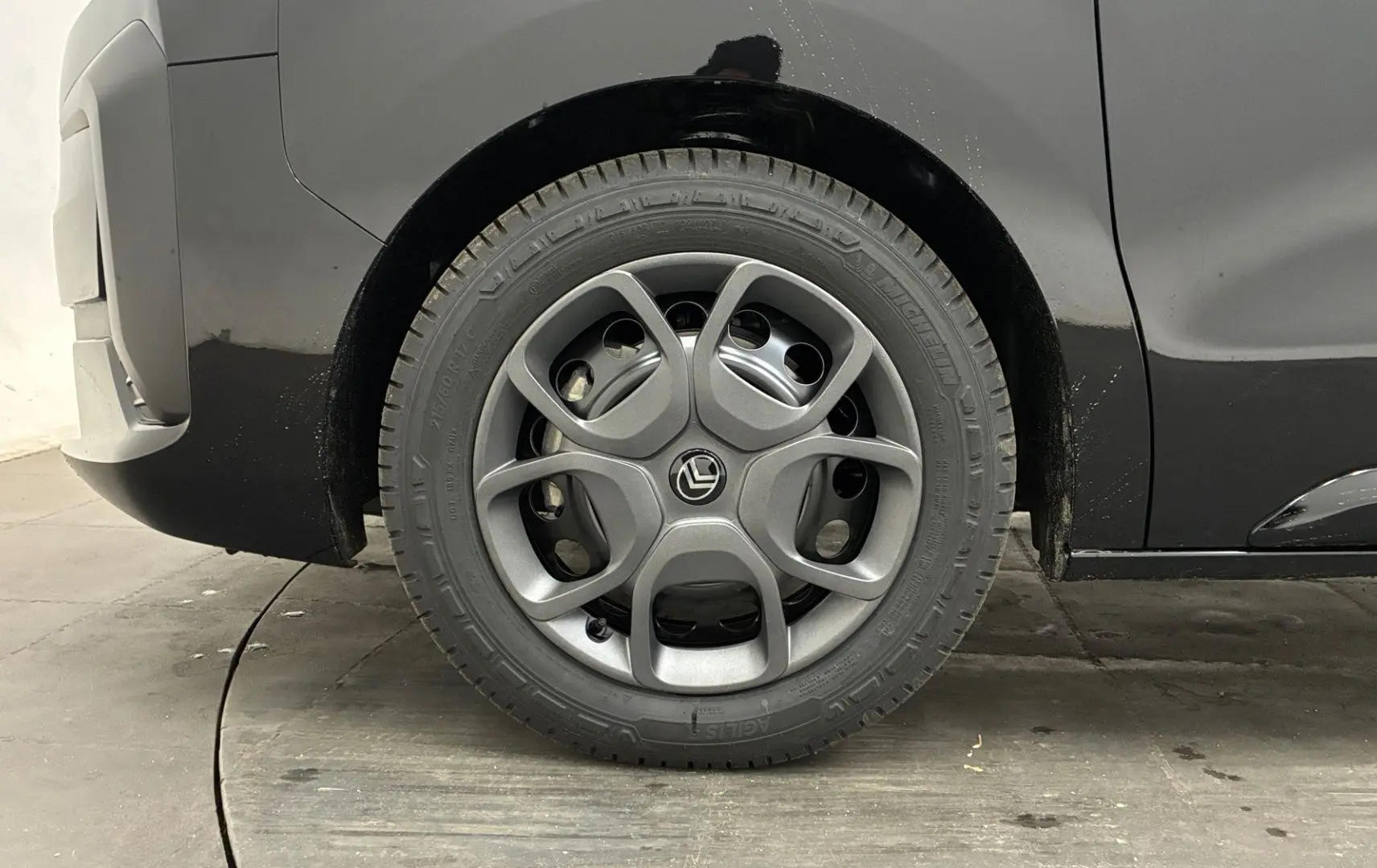 Gros plan sur la roue arrière droite d’un Citroën Jumpy Cabine Approfondie noir avec jante tôle 17 pouces et enjoliveur gris.