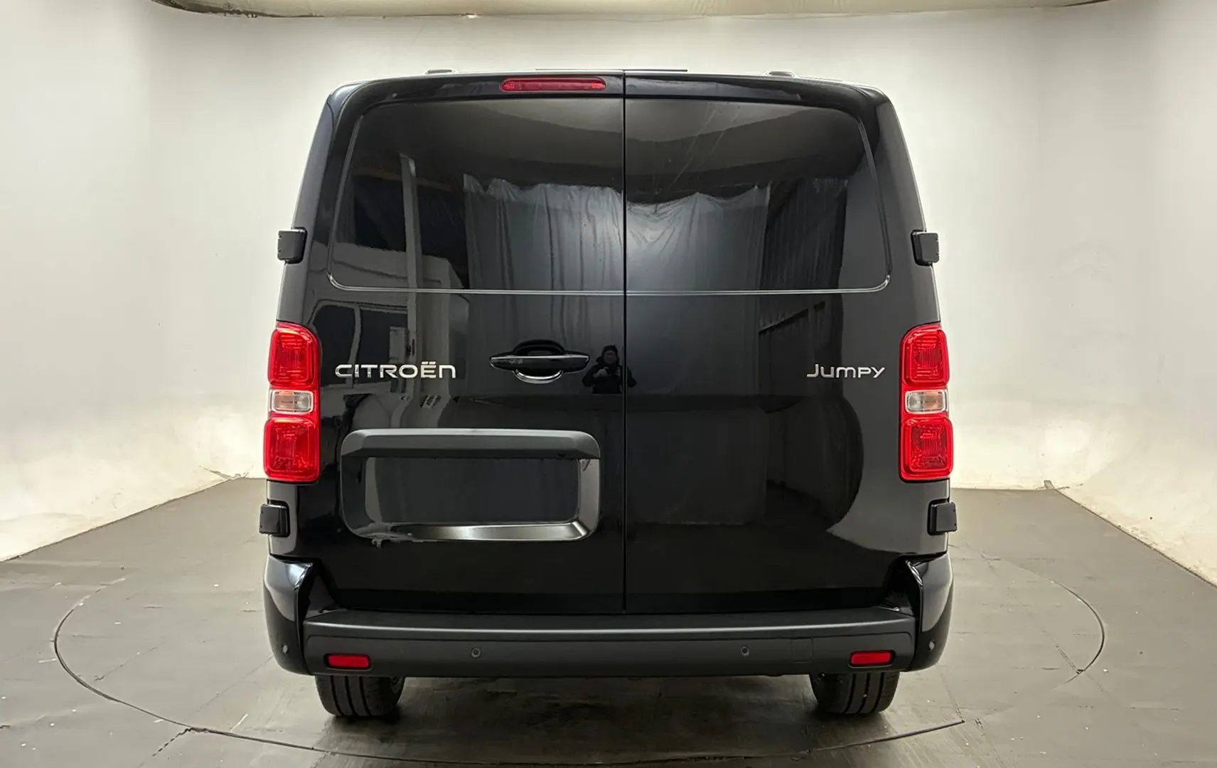 Vue arrière d’un Citroën Jumpy Cabine Approfondie noir avec portes battantes et feux rouges verticaux.