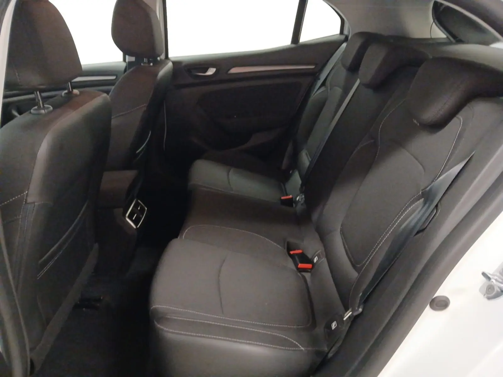 Vue intérieure côté droit des sièges arrière noirs avec surpiqûres blanches de la Renault Mégane IV blanche PH2 BlueDCI 115 Zen 2020.