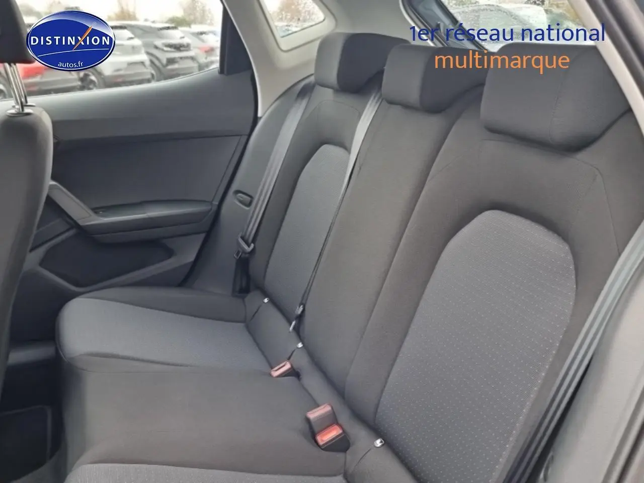 Vue intérieure côté droit sur la banquette arrière gris foncé de la SEAT Ibiza 2025 avec appuie-têtes et ceintures visibles.