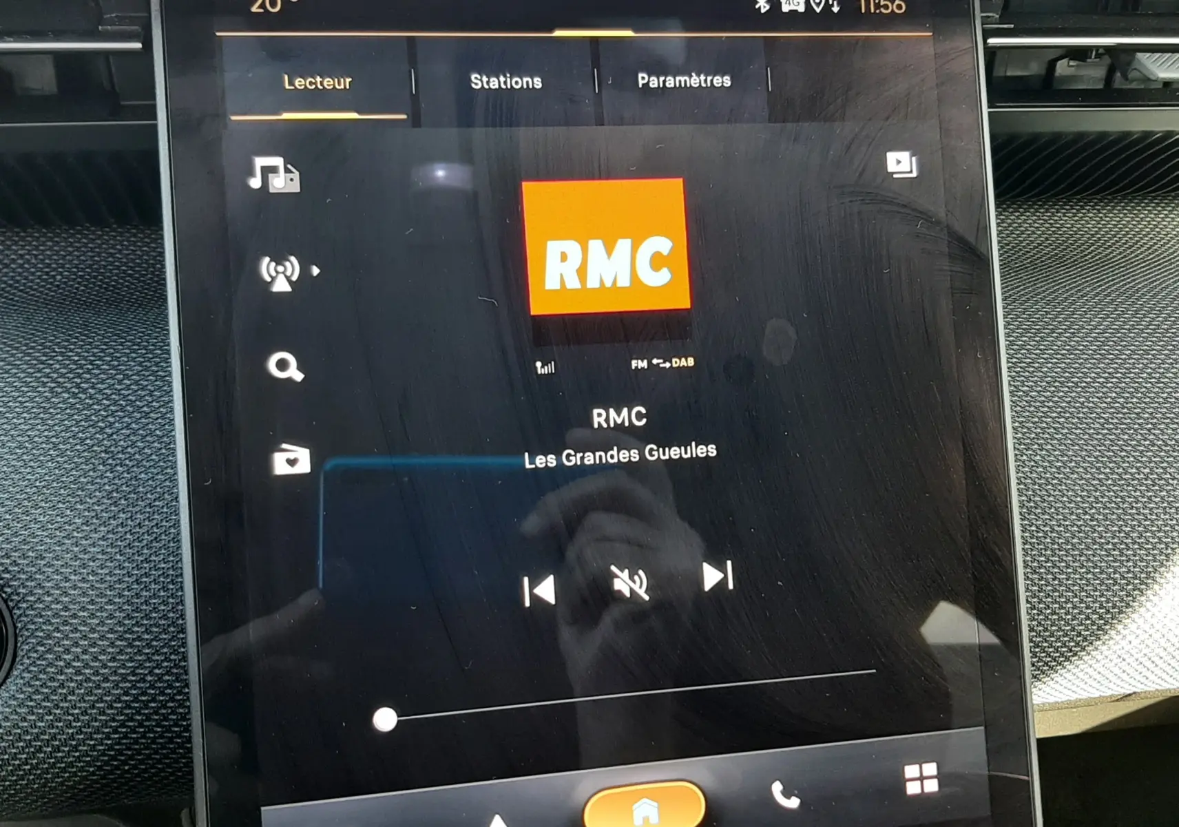Écran tactile central du Citroën C5 Aircross hybride 2026 affichant la radio RMC, ambiance intérieure noire.