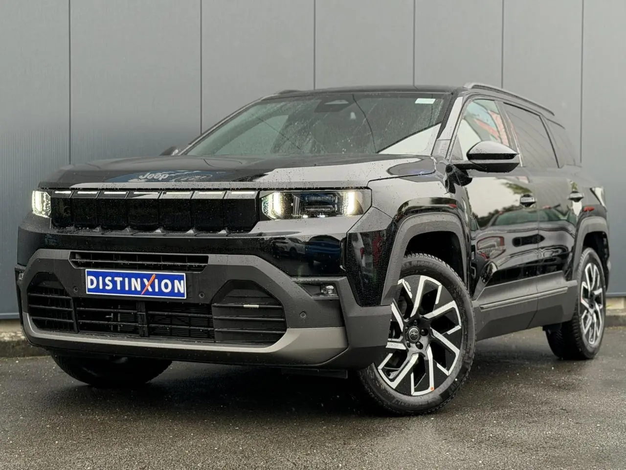 Jeep Compass Hybrid 2026 noir Vulcano en 3/4 avant droit, avec jantes alliage et feux LED allumés.