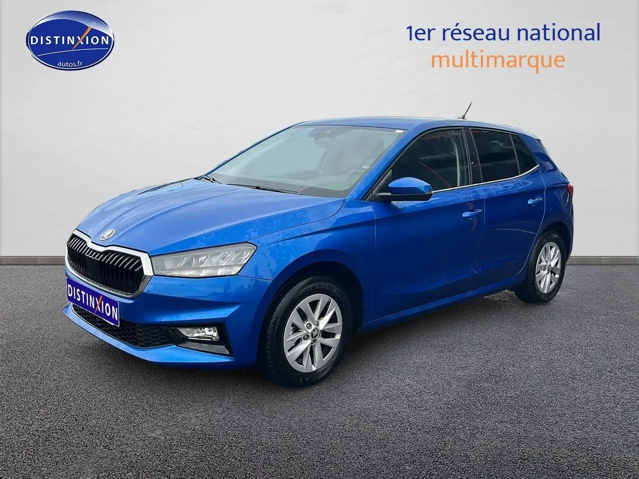 Vue 3/4 avant d'une Skoda Fabia bleu vif avec jantes alu et phares avant LED sur fond neutre.