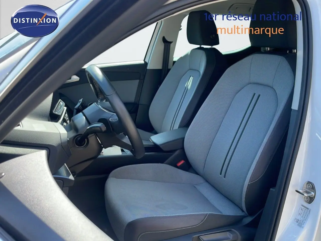 Vue intérieure côté conducteur du siège avant gris clair avec détails noirs d'une SEAT LEON blanche 2025.