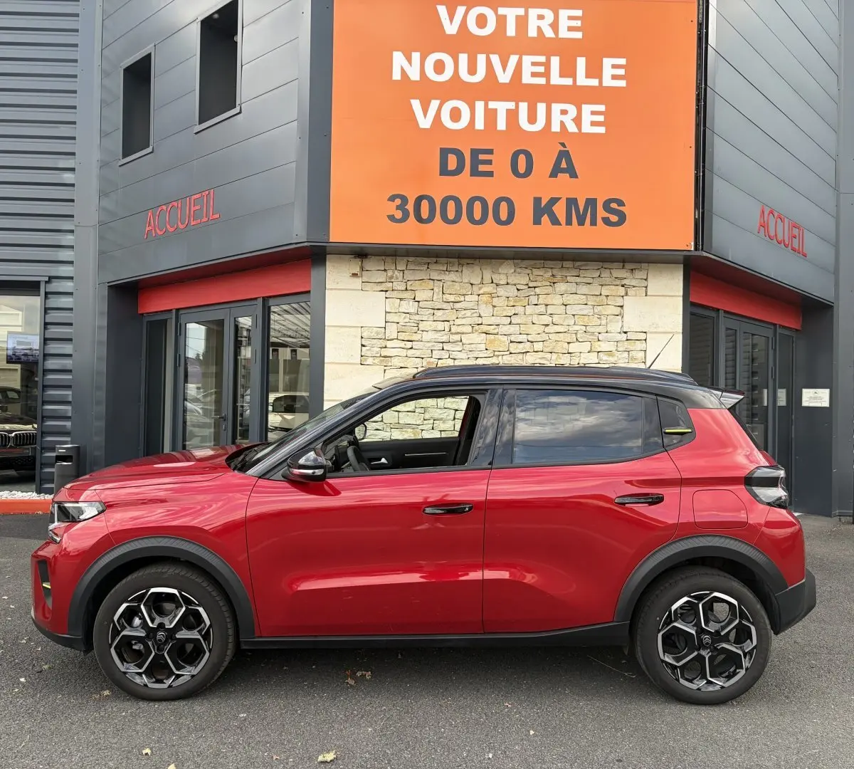 Profil droit d'une Citroën C3 Turbo 100 BVM6 MAX rouge 2025, avec jantes noires et toit noir contrasté.