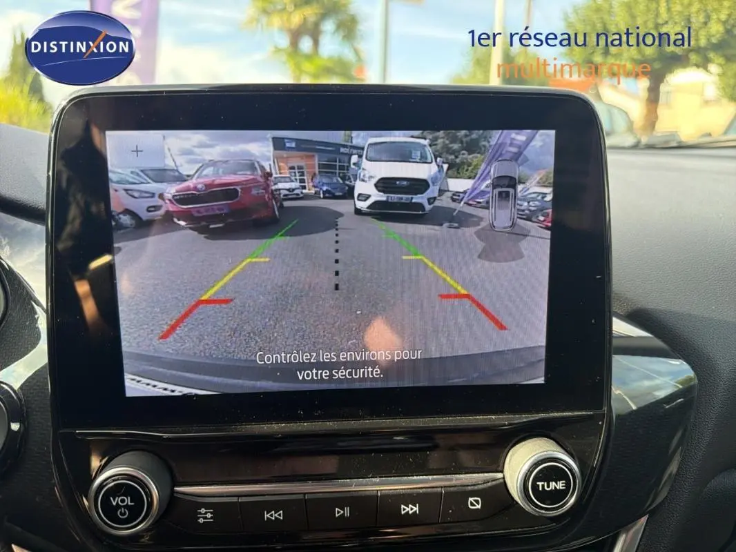 Écran tactile intérieur montrant la caméra de recul d’un Ford Puma gris foncé, vue arrière avec guidage de trajectoire.