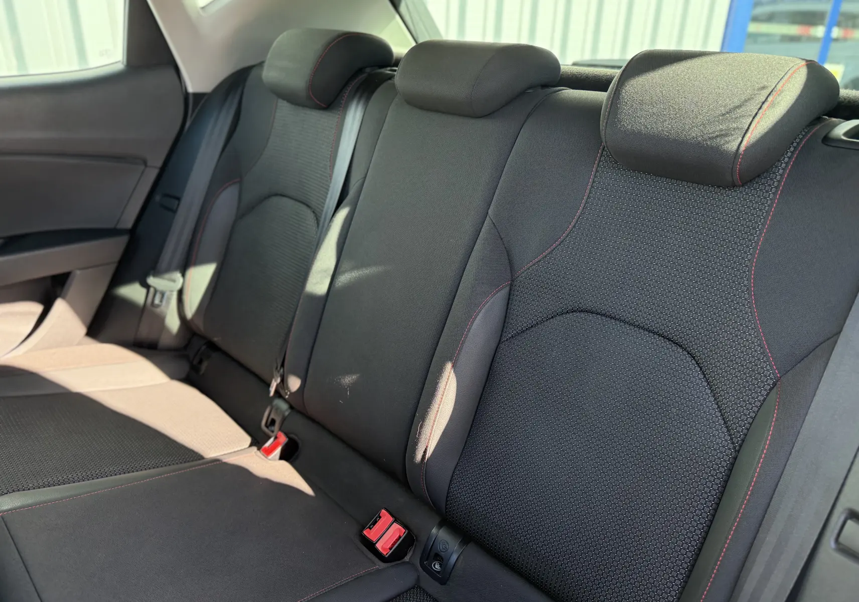 Vue rapprochée des sièges arrière noirs avec surpiqûres rouges du SEAT Leon 1.8 TFSI 180 FR de 2014.