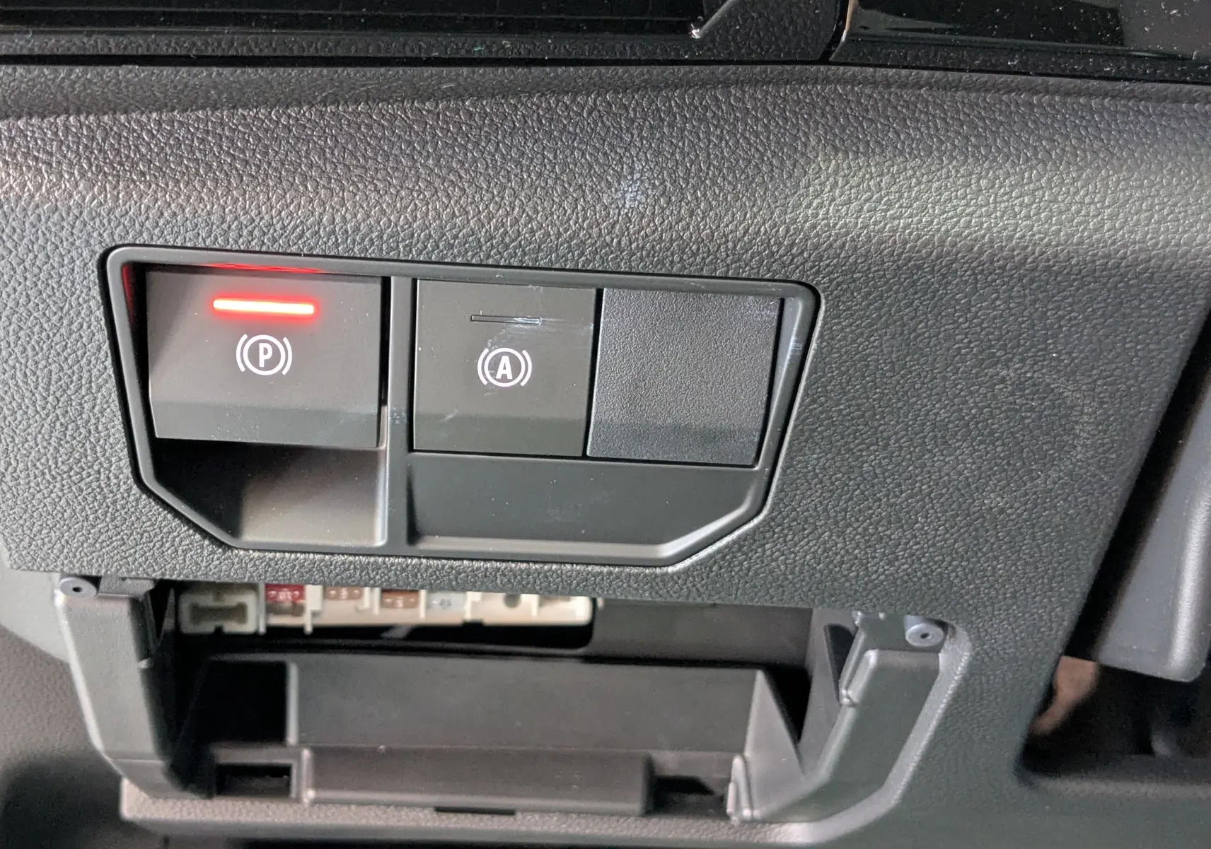 Gros plan sur les commandes de frein à main électronique et arrêt auto du Renault Austral E-Tech 200 Esprit Techno.
