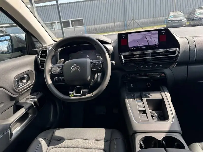 Vue intérieure du poste de conduite du Citroën C5 Aircross gris Platinium, avec écran tactile et volant multifonction.