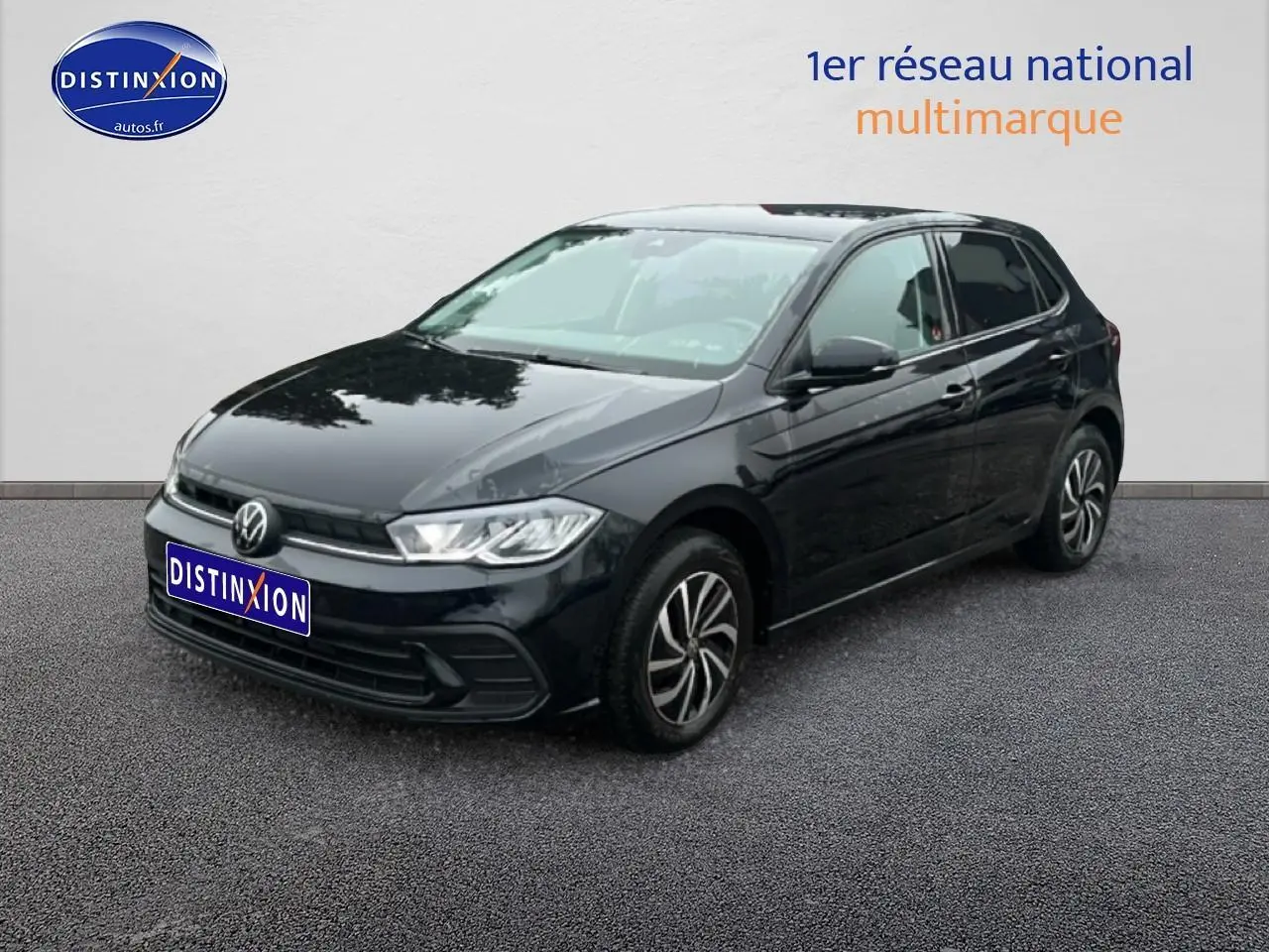 Volkswagen Polo noir intense nacré vue 3/4 avant droit sur sol gris devant mur blanc.