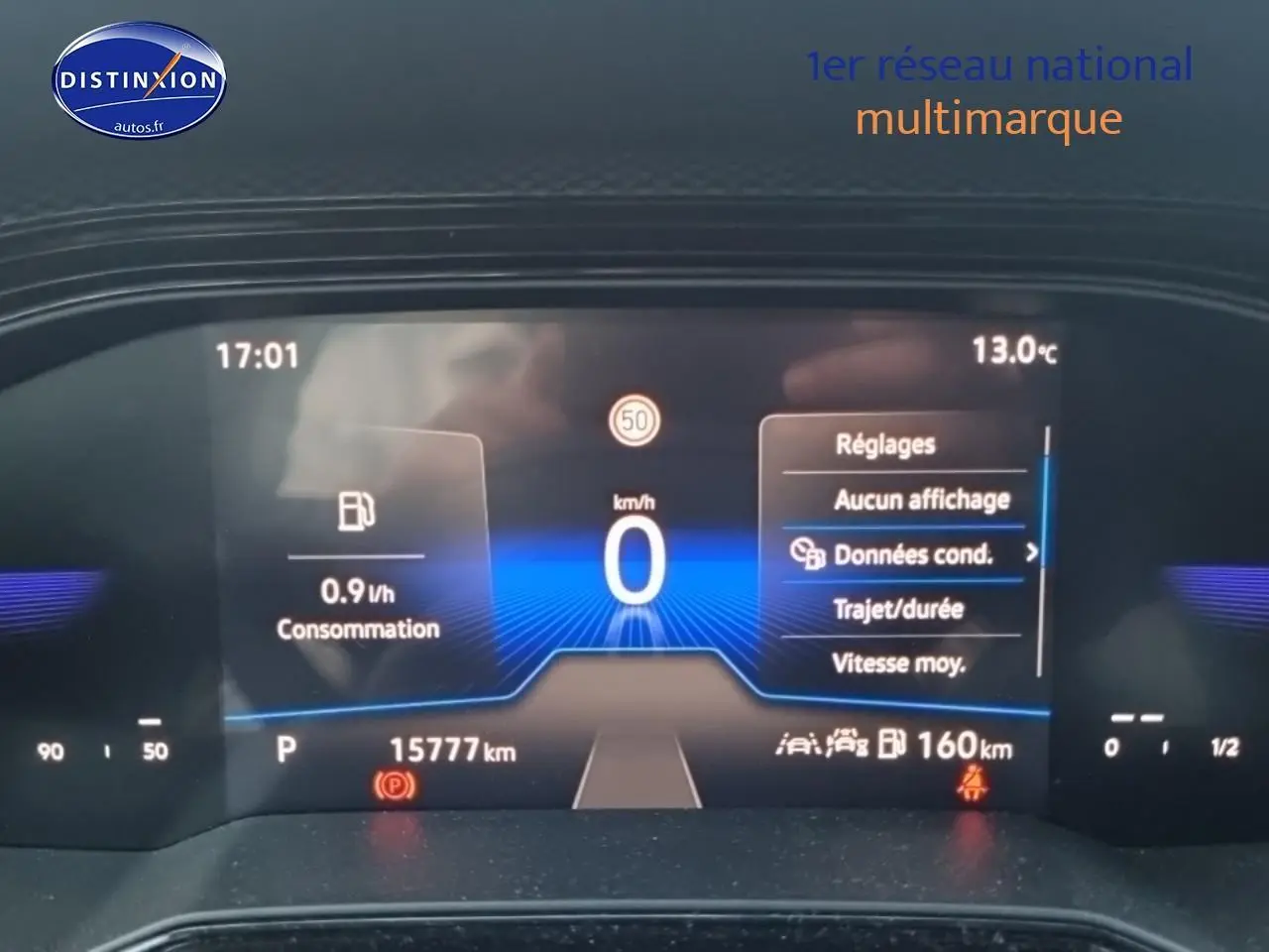 Affichage digital du tableau de bord de la Volkswagen Polo noir intense, montrant la consommation et la vitesse à l'arrêt.