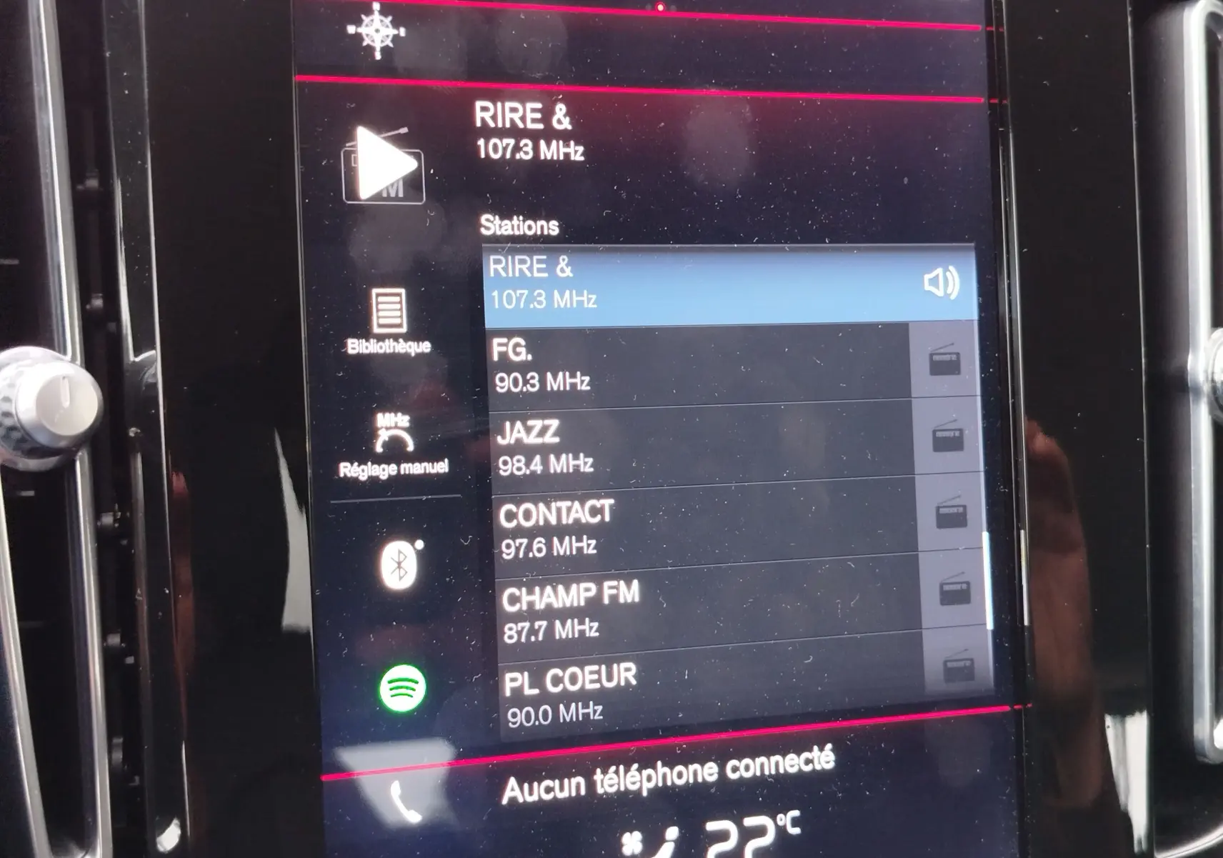 Écran tactile central du Volvo XC40 beige de 2020 affichant les stations radio FM et la température intérieure à 22°C.