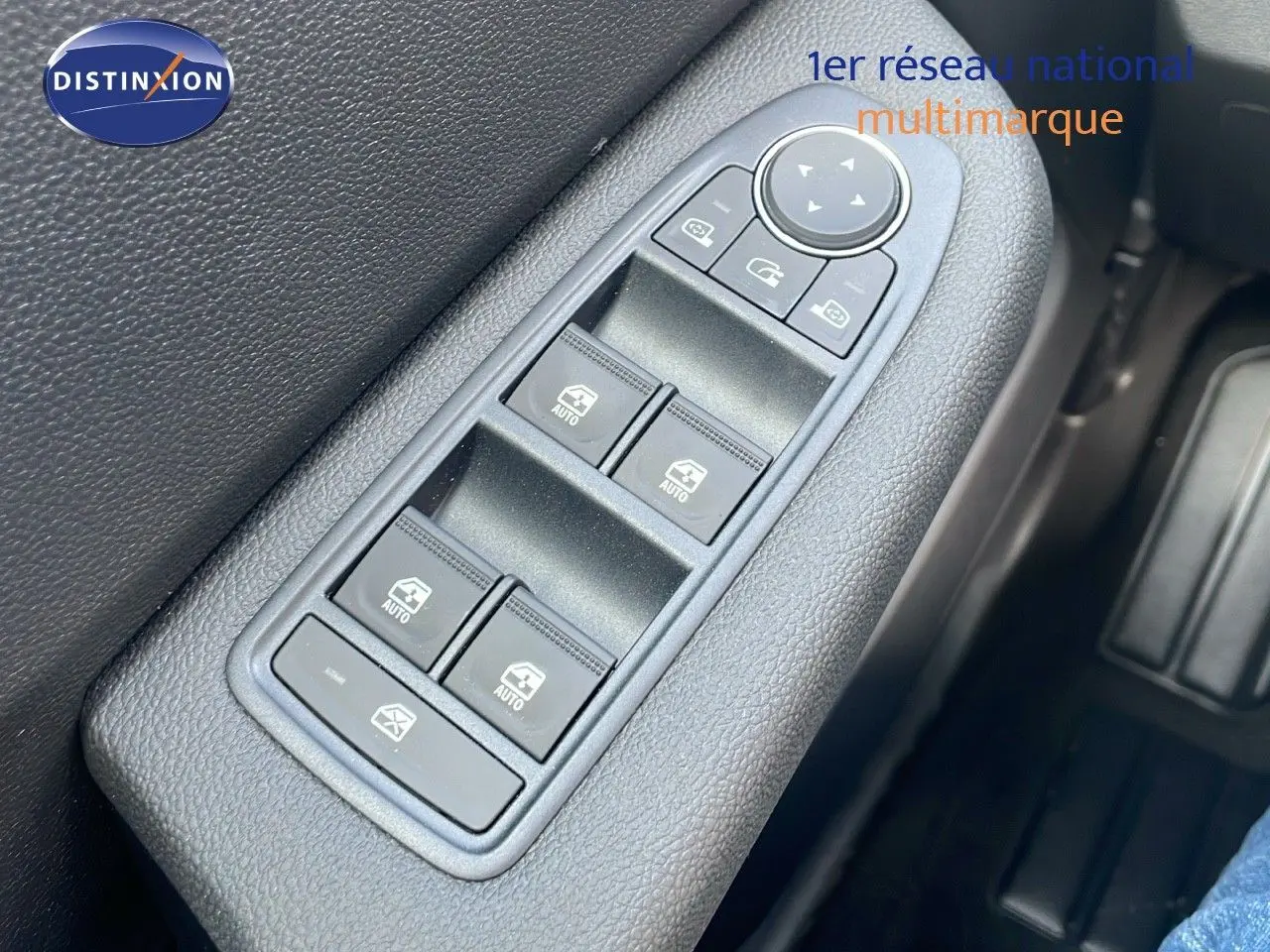 Panneau de commandes des vitres électriques côté conducteur dans une Renault Clio gris schiste métal, intérieur noir.