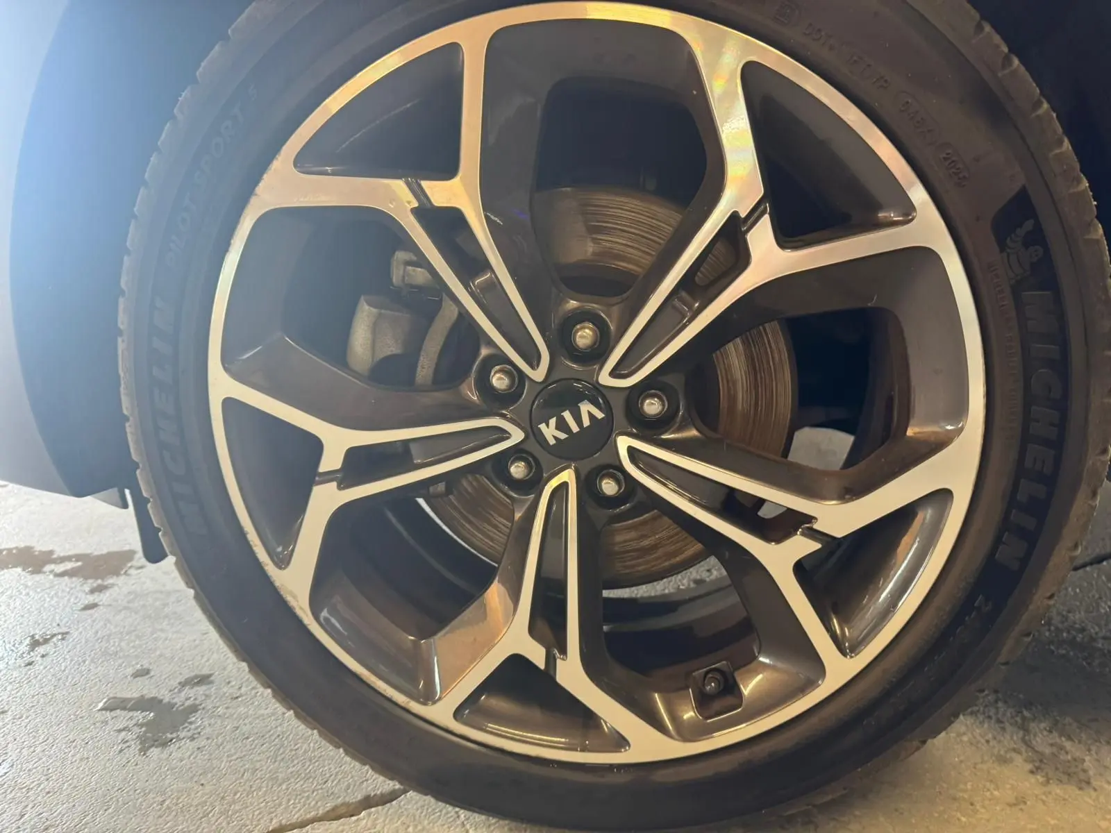 Gros plan sur la jante alliage bicolore du KIA SPORTAGE 1.6 CRDI 136 GT LINE avec logo central KIA visible.