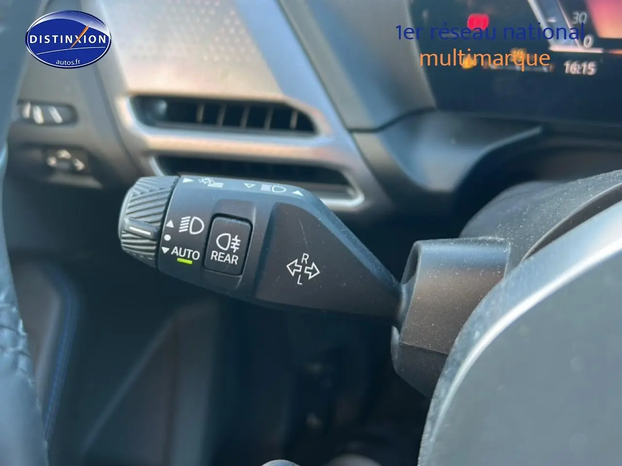 Gros plan sur la commande des feux et clignotants dans l’habitacle d’une BMW Série 1 blanche Alpine 2025.