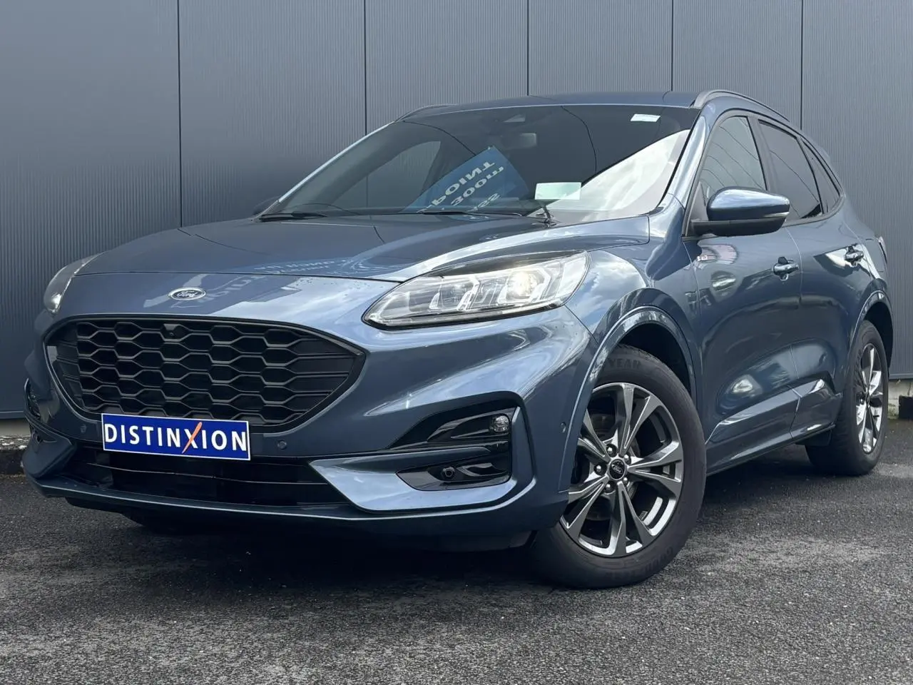 Ford Kuga bleu azur en 3/4 avant droit avec calandre noire et jantes alliage 18 pouces ST-Line.