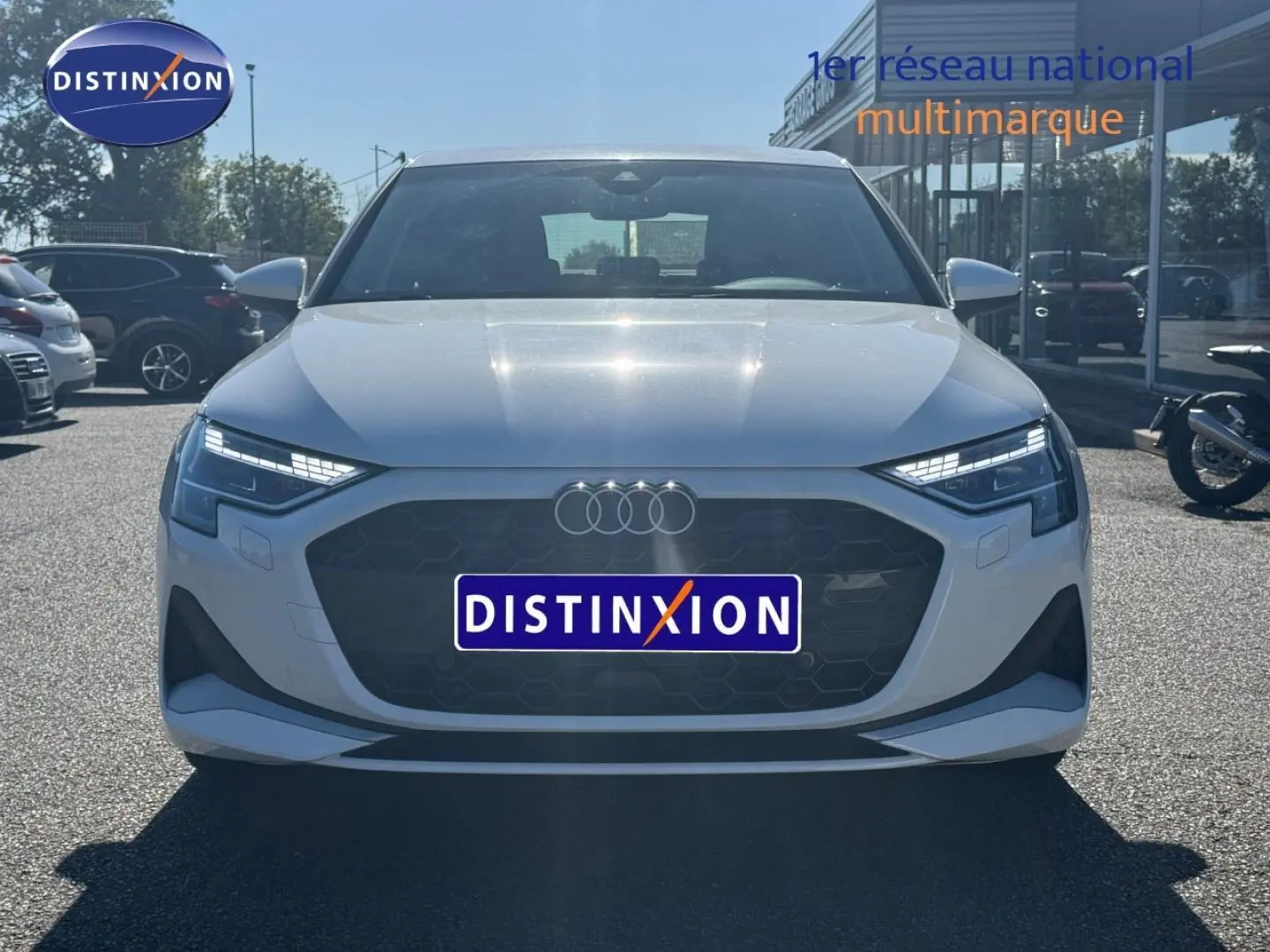 Vue avant d'une Audi A3 Sportback 30 TFSI blanche Arkona avec calandre noire et phares LED distinctifs.