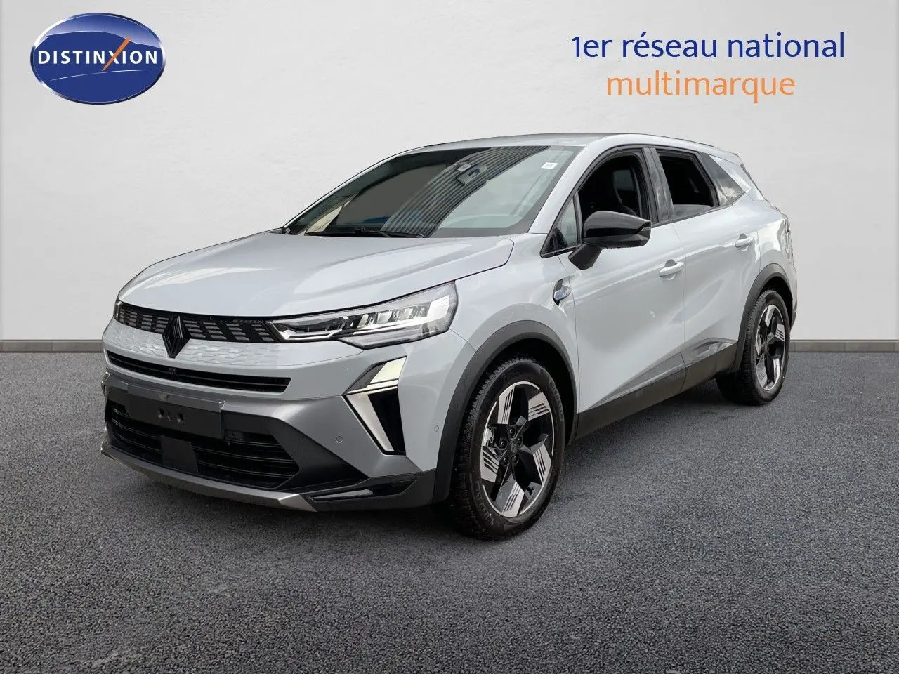 Renault Symbioz gris Rafale métal en 3/4 avant droit, SUV hybride avec détails noirs et jantes stylisées.