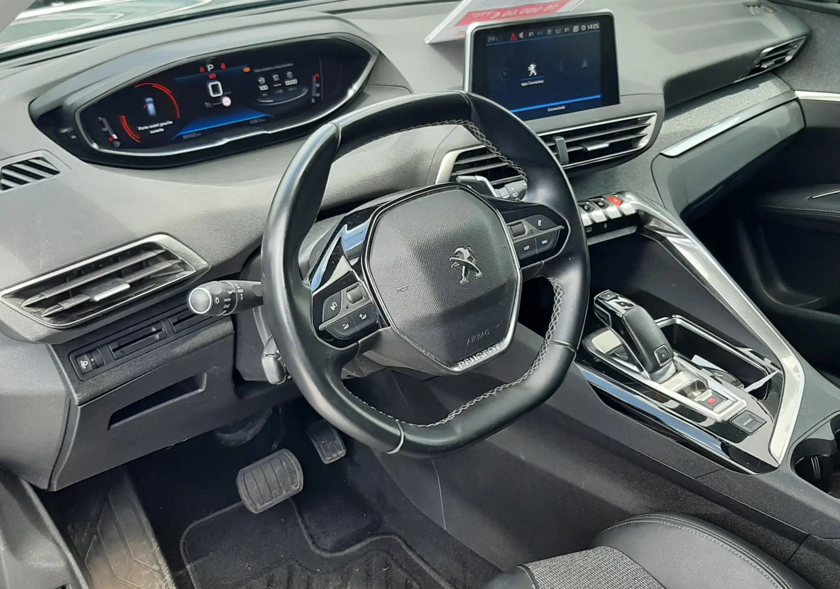 Intérieur avant droit du Peugeot 3008 gris 2020, volant multifonction, tableau de bord numérique et console centrale moderne.