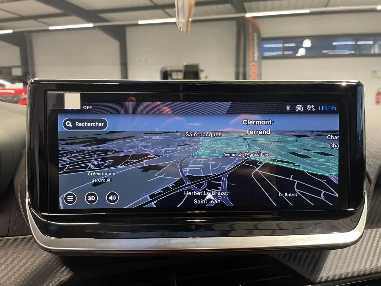 Écran tactile central du tableau de bord de la Peugeot 208 gris Selenium affichant la navigation GPS en intérieur.
