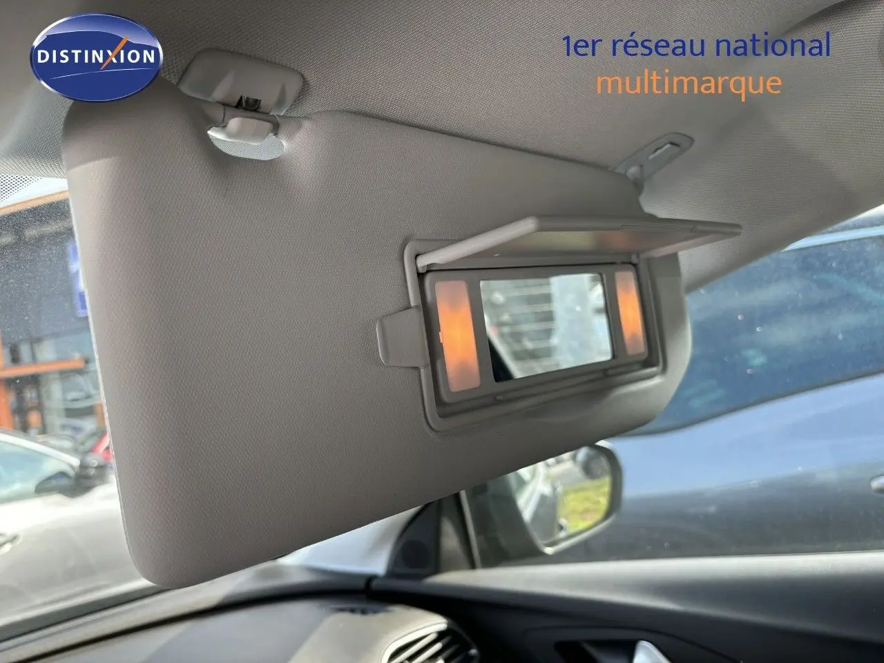 Détail intérieur du pare-soleil avec miroir éclairé côté conducteur d’un Opel Grandland X noir, vue depuis l’habitacle.