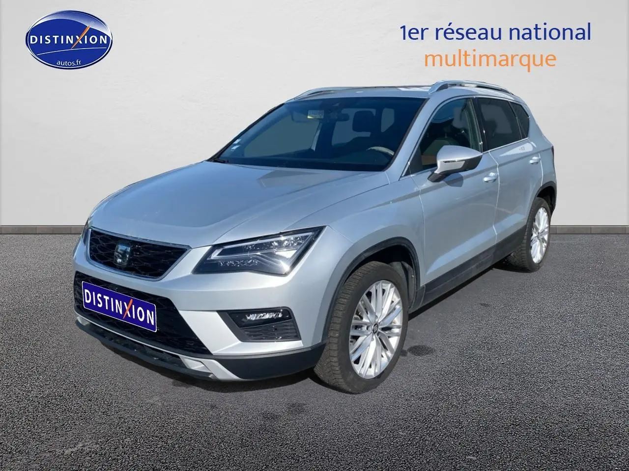 SEAT Ateca gris en 3/4 avant droit, avec jantes alliage et calandre noire distinctive.