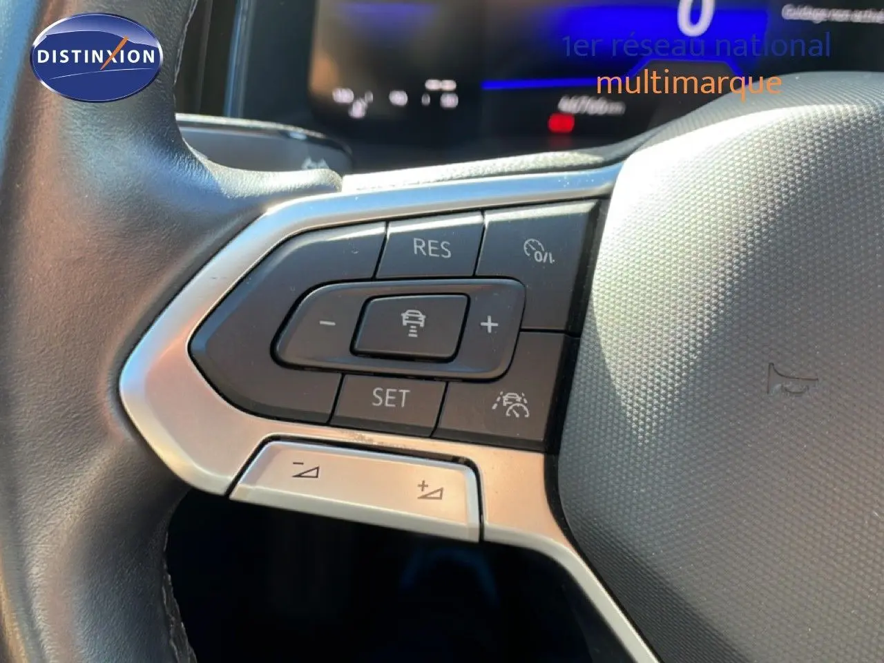 Gros plan sur les commandes au volant côté gauche du Volkswagen Taigo 2022 en finition Life Business, volant cuir noir.