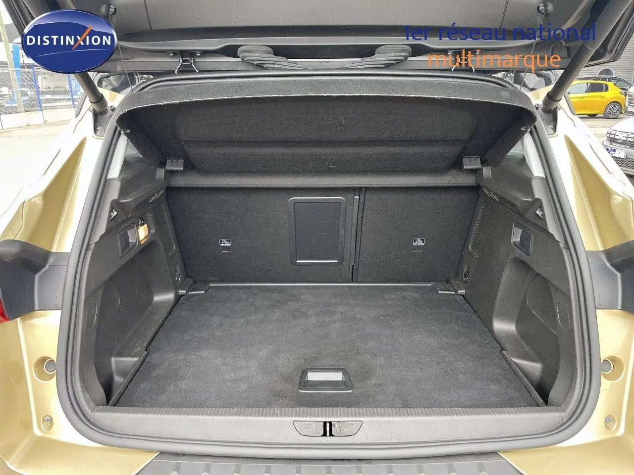 Coffre ouvert vu de l'arrière d'un Opel Grandland X 2018 couleur Golden Sunstone Metal, montrant un espace de chargement propre et spacieux.