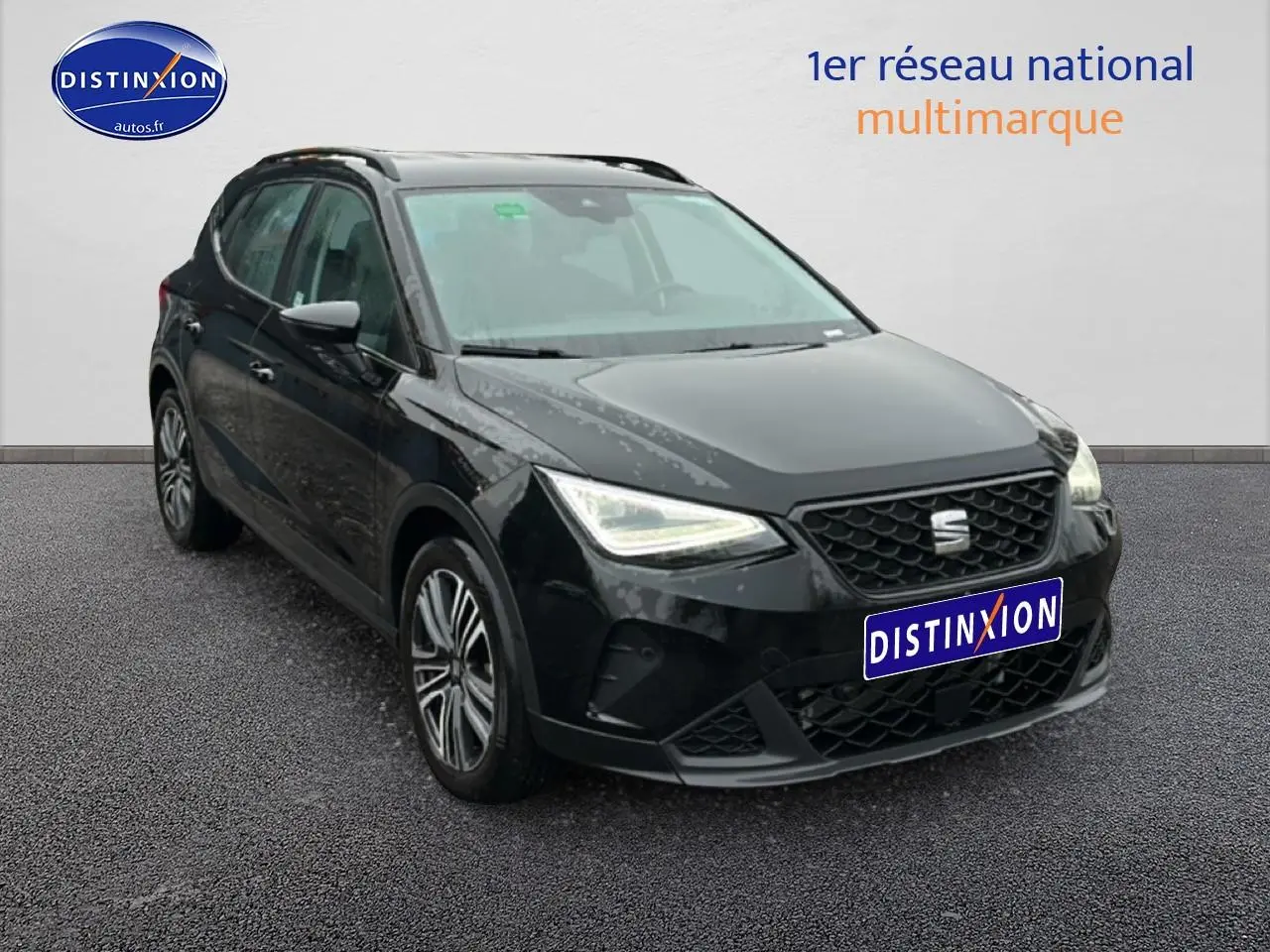 Vue 3/4 avant droite d'une SEAT Arona noir minuit avec jantes 17 pouces et signature lumineuse triangulaire des phares LED.