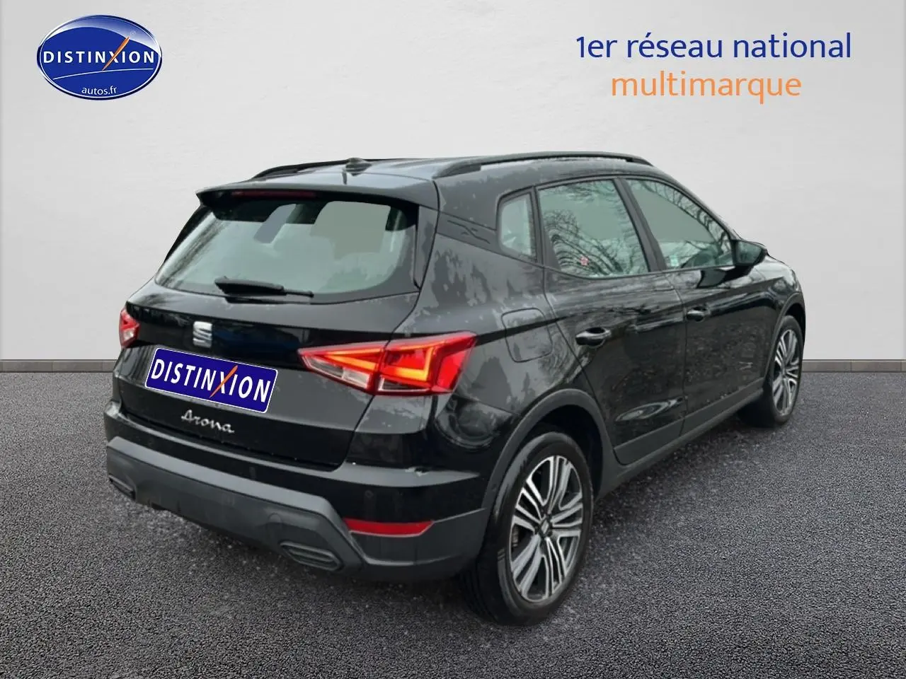 Vue 3/4 arrière droite d'un SEAT Arona noir minuit avec jantes 17 pouces et signature manuscrite sur hayon.