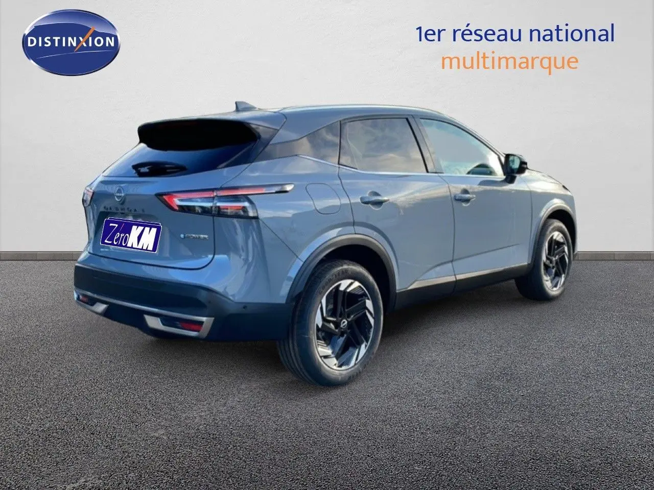 Vue 3/4 arrière droite du Nissan Qashqai gris argile métal avec jantes noires et toit noir contrasté.
