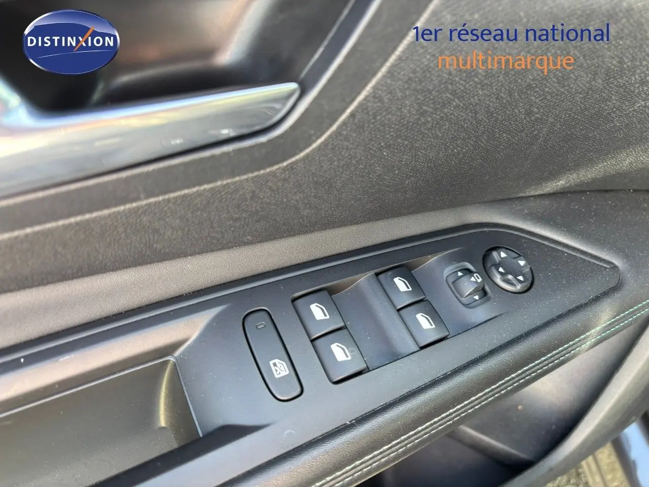 Gros plan sur les commandes des vitres côté conducteur d’un Peugeot 3008 gris platinium 2022 hybride rechargeable.