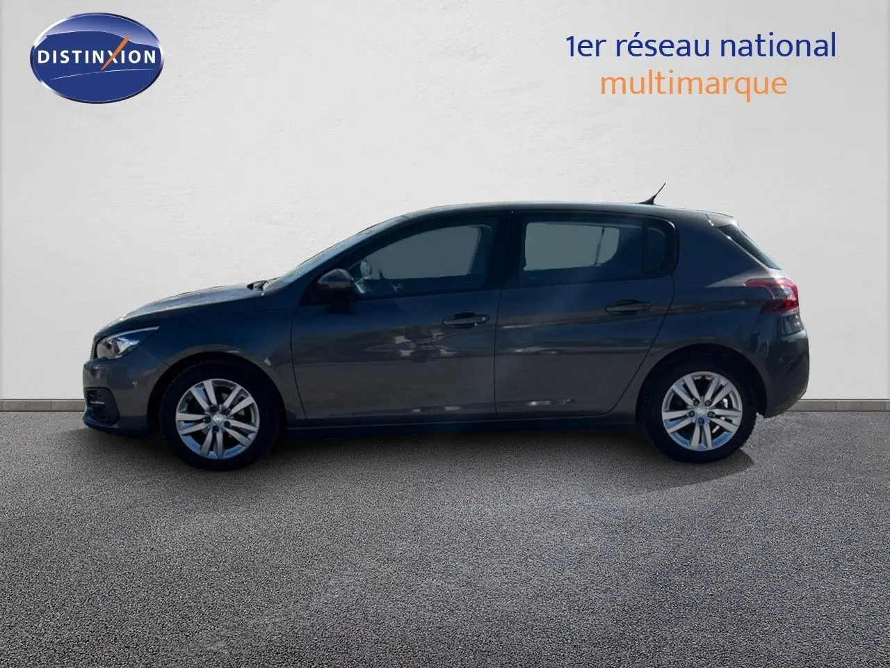 Profil côté gauche d'une Peugeot 308 Business gris foncé de 2020, compacte et élégante, sur fond neutre.