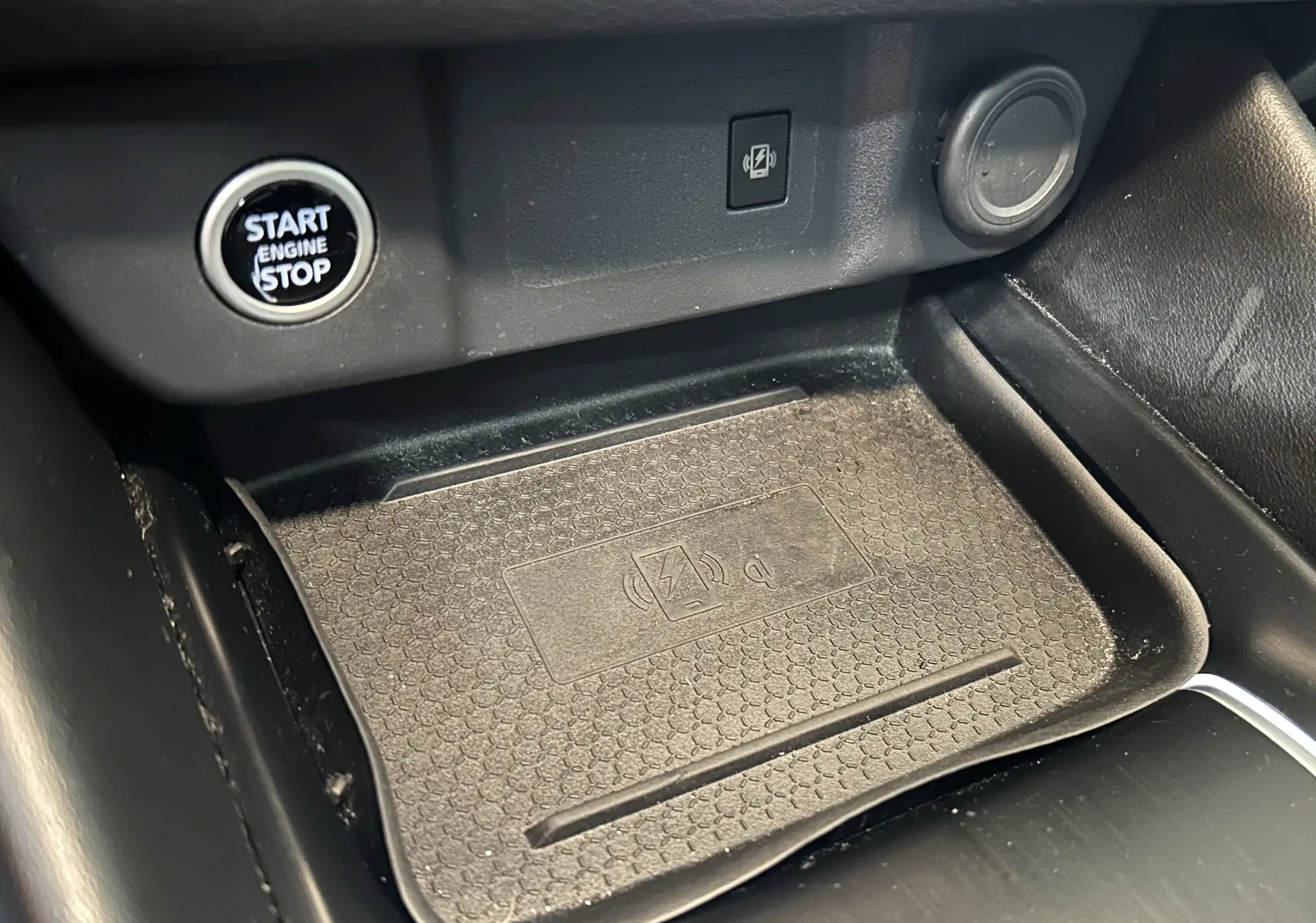 Détail de la console centrale du Nissan Qashqai 2023 avec bouton Start/Stop et zone de charge sans fil.