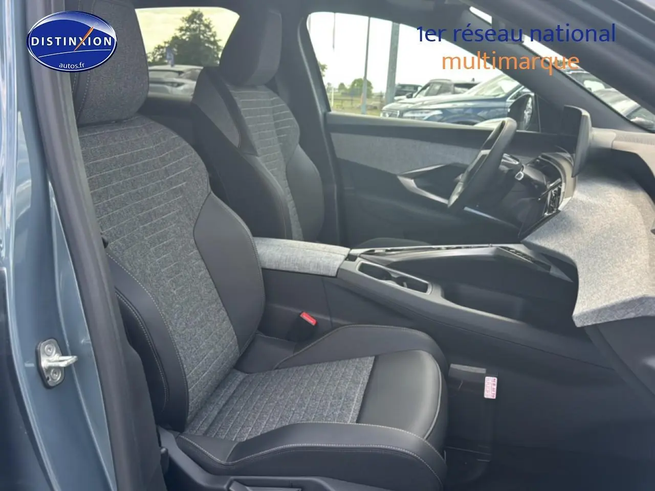 Vue intérieure côté gauche du Peugeot 3008 bleu 2025, montrant sièges tissu et cuir, console centrale et tableau de bord.