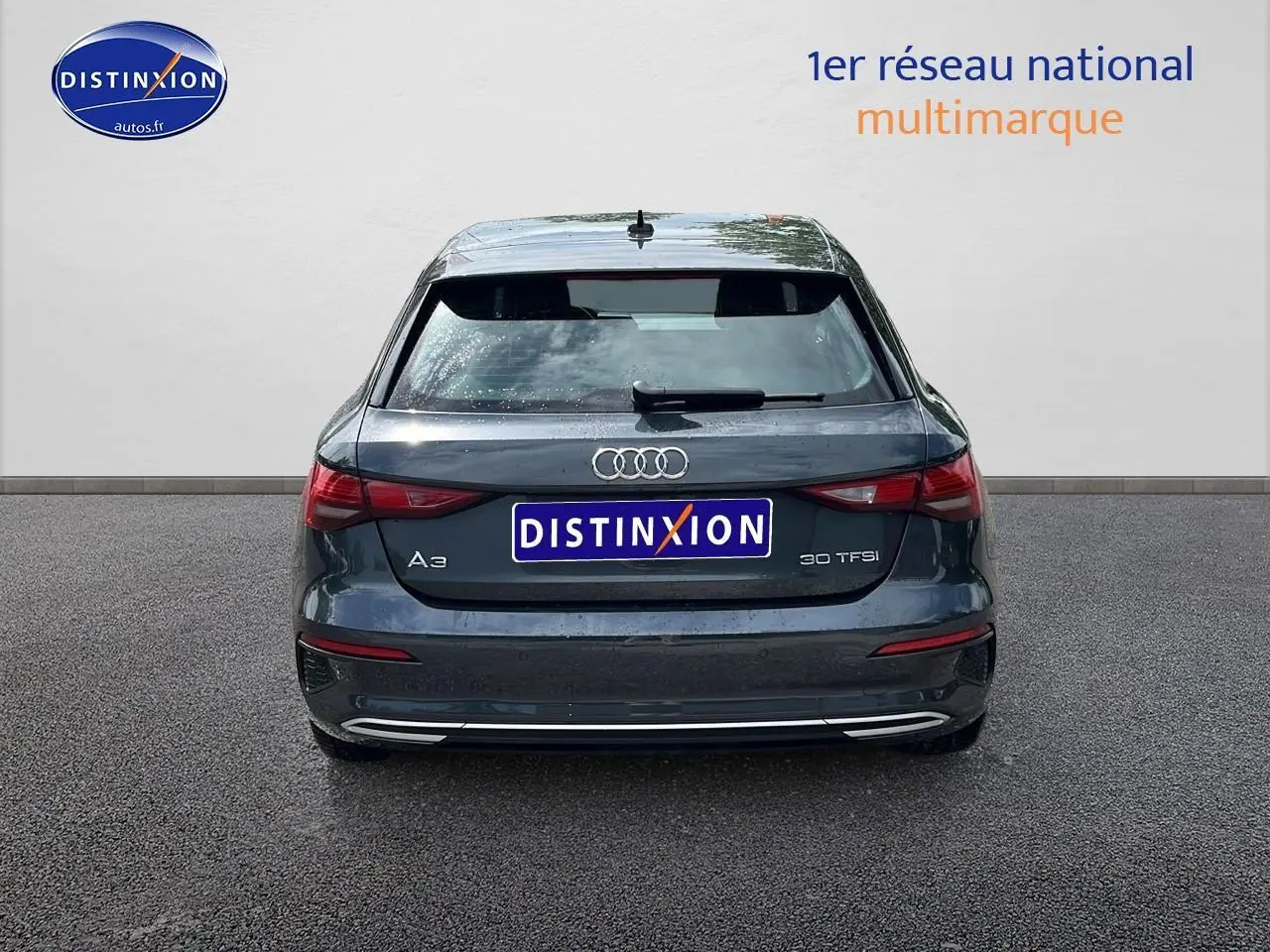 Vue arrière d'une Audi A3 Sportback gris Manhattan 2023 avec feux LED et logo distinctif sur hayon.