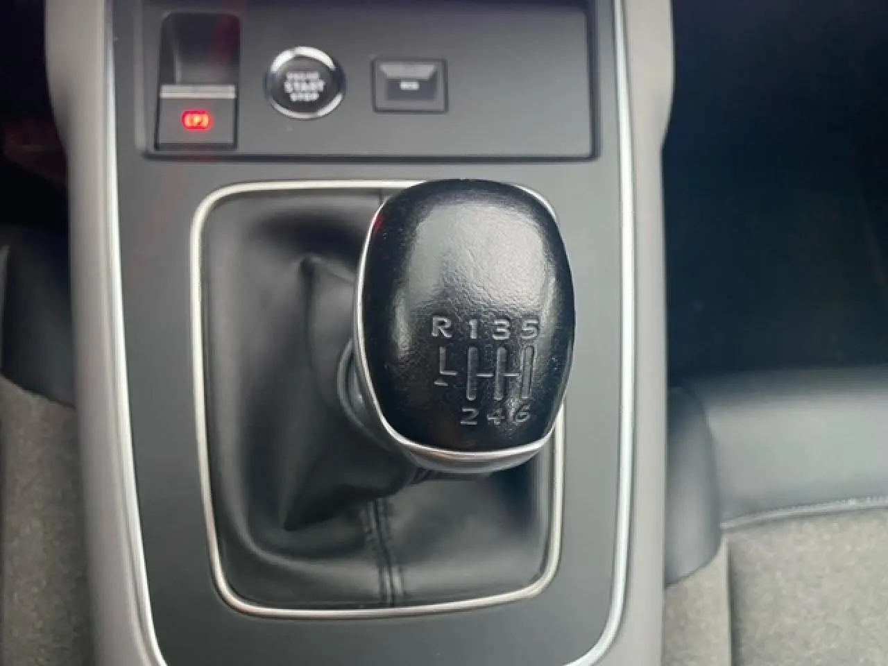 Gros plan sur le levier de vitesses manuel noir du Citroën C5 Aircross 2021, entouré de garniture intérieure sombre.